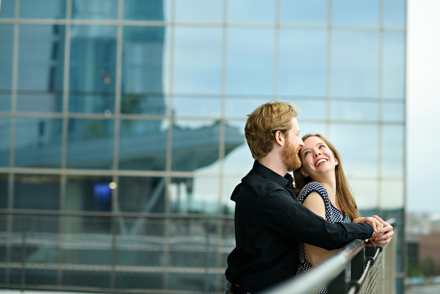 A couple enjoy the view of philadelphia during their engagement session.
